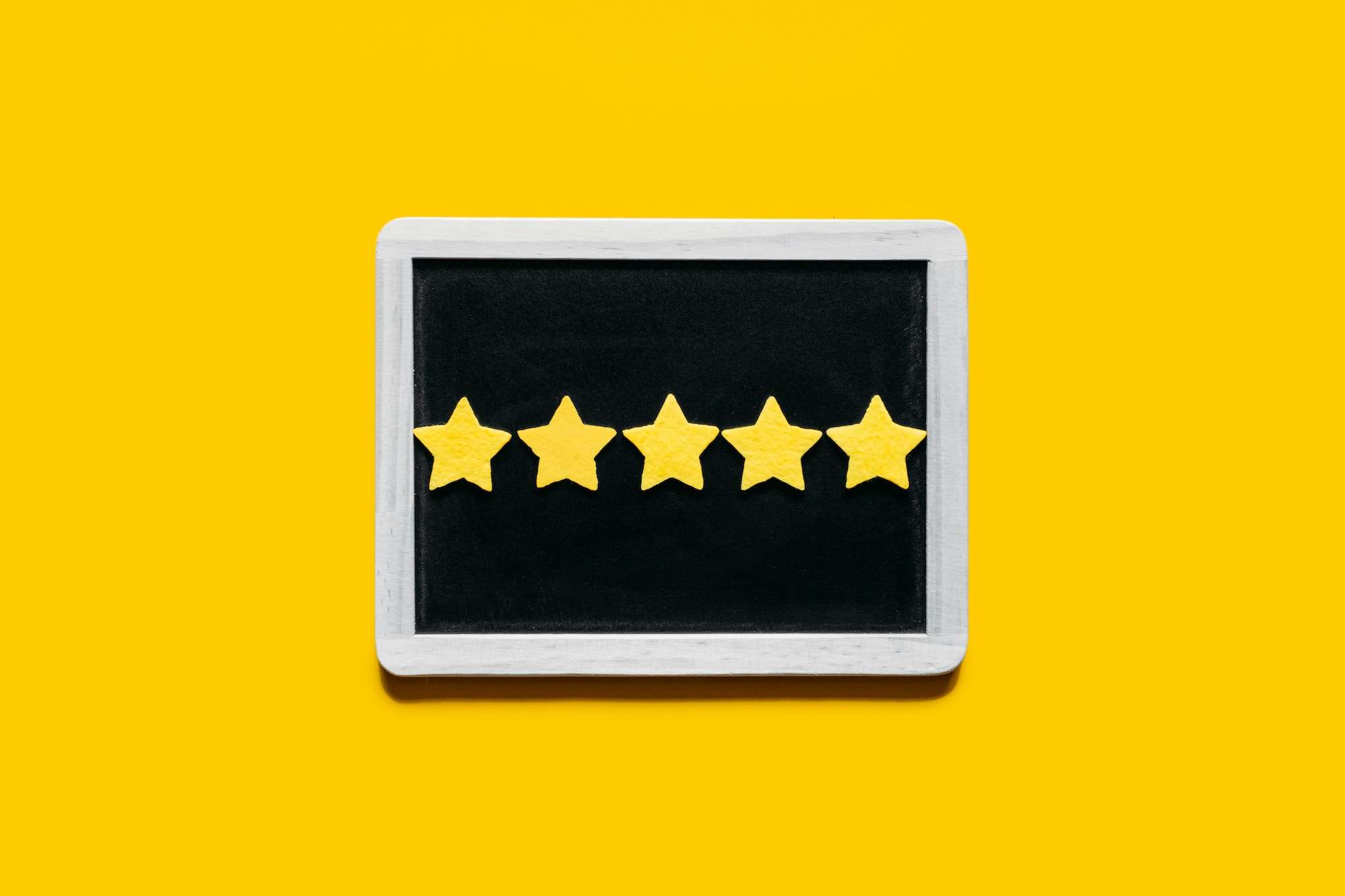 Customer Experience, Review Concept. Five yellow stars excellent rating in frame on yellow