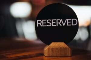 Reservation card on festive table shows occupied place by customers